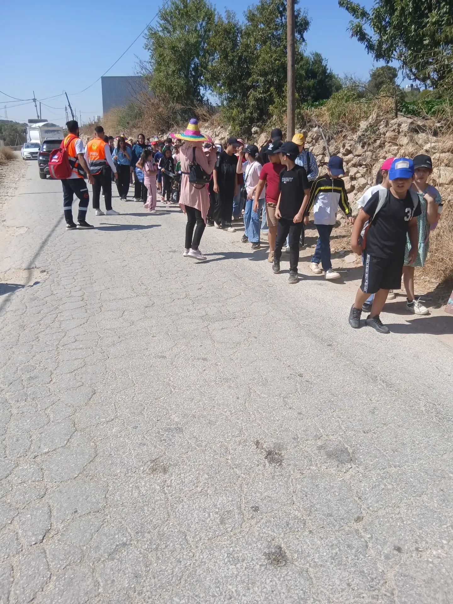 Children and supervisors on an environmental field trail in Beit Ummar